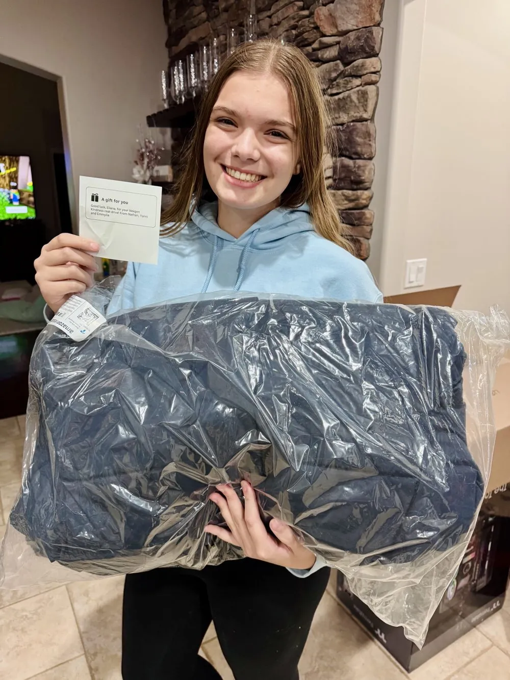 A volunteer holding a donated winter coat