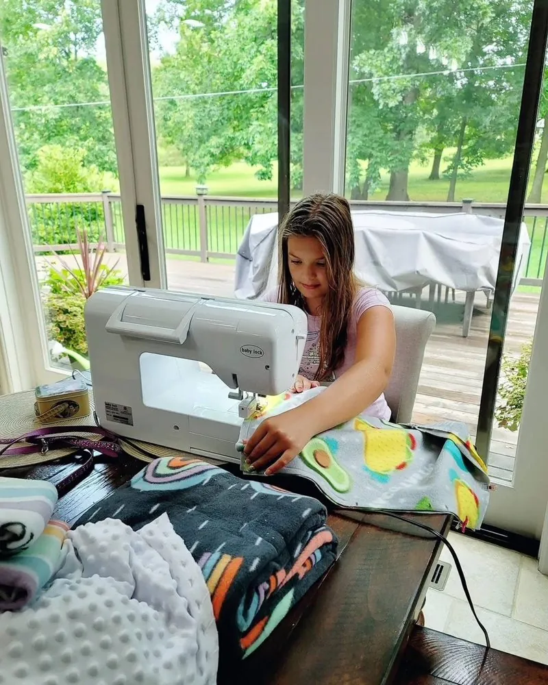 Eliana sewing a blanket